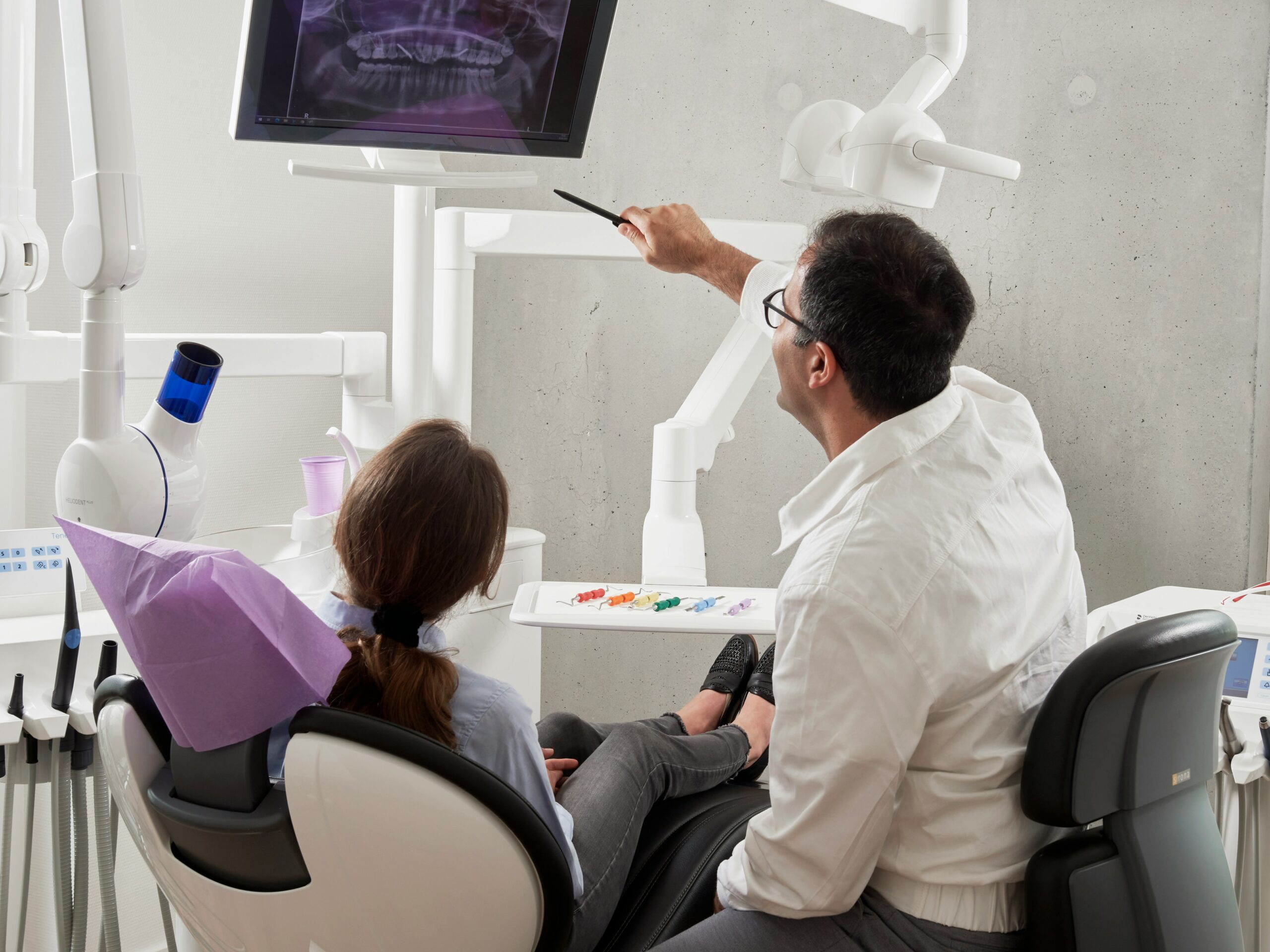Dentist and patient viewing an xray of teeth